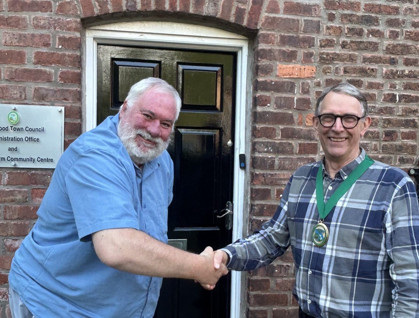 Cllr Nigel Reeves congratulating Cllr David Ellis on becoming Chair for 2026/27